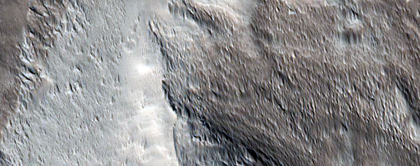 Valley Cutting Crater Rim in Acheron Fossae
