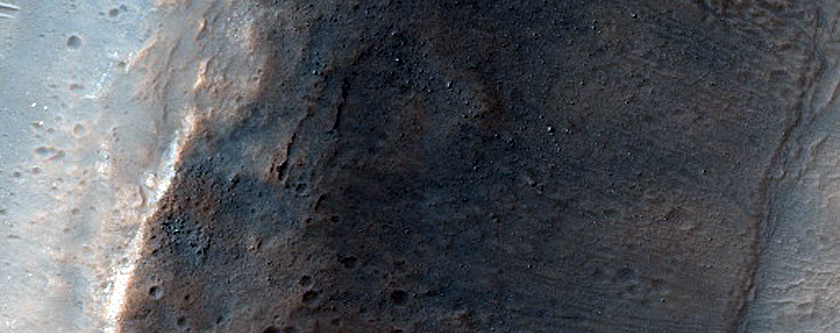 Olivine and Pyroxene-Rich Mantled Crater Rim in Promethei Terra
