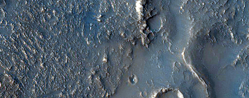 Terminus of Pitted Materials Emanating from Oudemans Crater