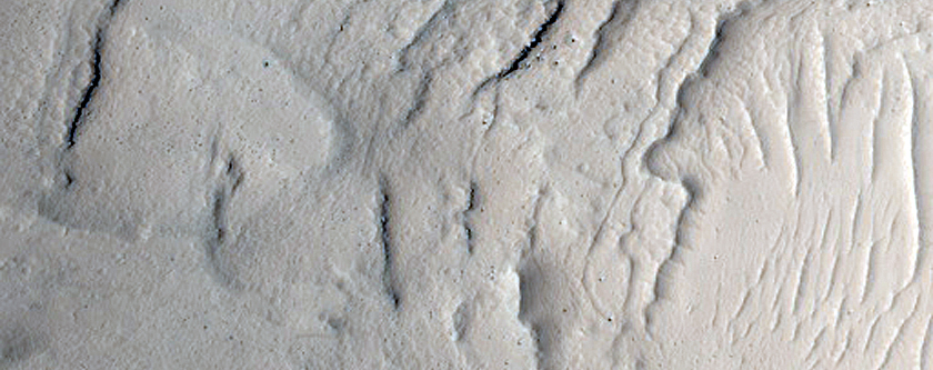 Crater with Interior Layer Exposure West of Echus Chasma

