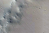 Crater Superposed on Trough
