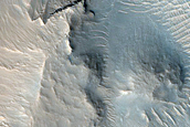 Layered Material in Intermountain Valleys West of Argyre Planitia
