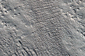 Flow of Material Through Gap in Crater Rim in Phlegra Montes
