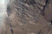Layers in Crater along Southwest Rim of Tikhonravov Crater
