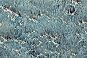 Layers in Floor of Larger Crater Exposed in Smaller Crater
