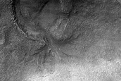 Crater with Breached Rim and Interior Terraced Landform

