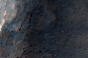 Olivine and Pyroxene-Rich Mantled Crater Rim in Promethei Terra
