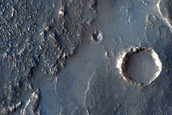 Terminus of Pitted Materials Emanating from Oudemans Crater

