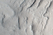Crater with Interior Layer Exposure West of Echus Chasma
