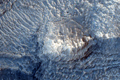 Pit on Crater Floor Exposing Layered Bedrock
