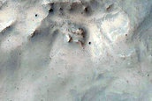 Crater with Exposed Layered Walls Superposed on Ejecta of Larger Crater
