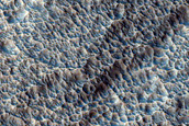 Heavily Pitted Distal Rampart Ejecta of Mojave Crater