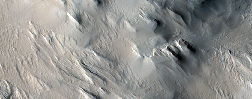 Layers and Ridges near Gordii Dorsum