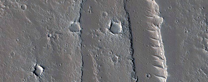 Conical Feature near Channels and Fissures in Tharsis Region