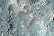 Incised Channel with Light-Toned Deposits in Intercrater Plain
