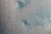 Layers in Floor of Larger Crater Exposed in Smaller Crater