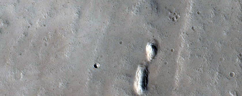 Fresh Crater with Bedrock Exposure and Glacial Deposit near Tractus Fossae