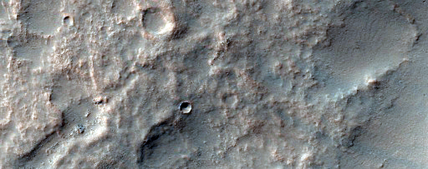 Curved Channels in Claritas Rupes