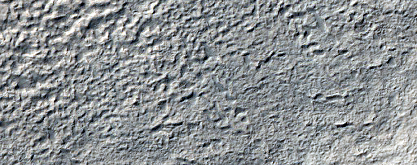 Fresh Crater with Layered Mesa near Euripus Mons