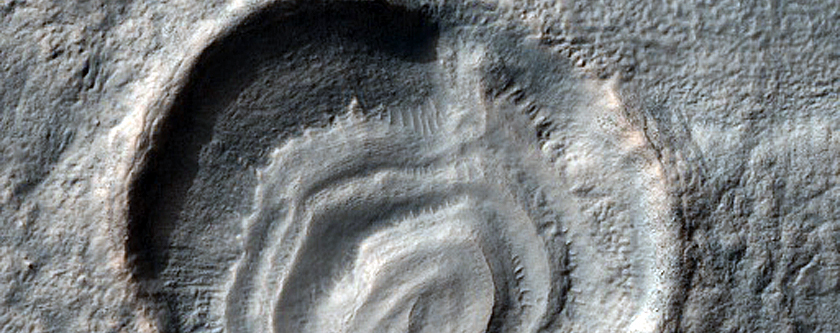 Crater with Layered Mesa South of Reull Vallis