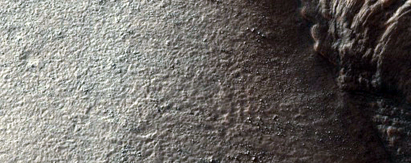 Layered Features along Scarp near Reull Vallis