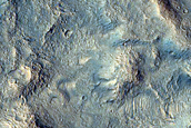 Eroded Layered Deposits on Floor of Orson Welles Crater