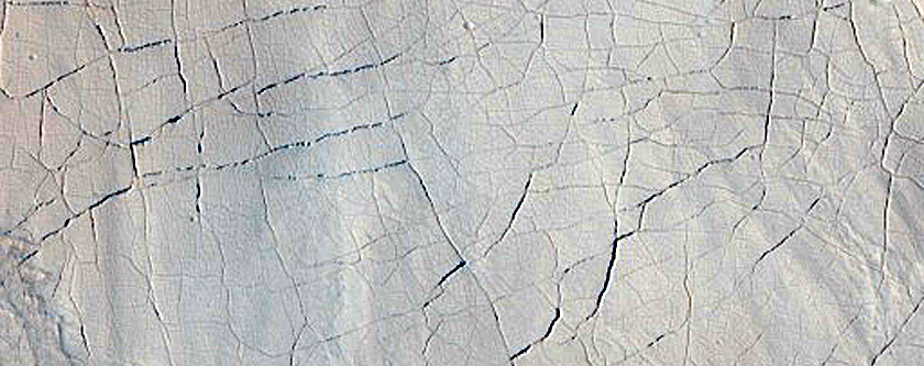 Fractures and Pits on Crater Floor Materials