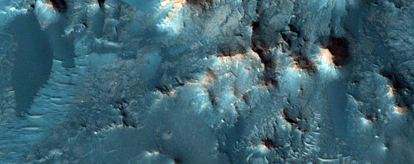 Layered Materials in Low Albedo Region near Deepest Point of Crater
