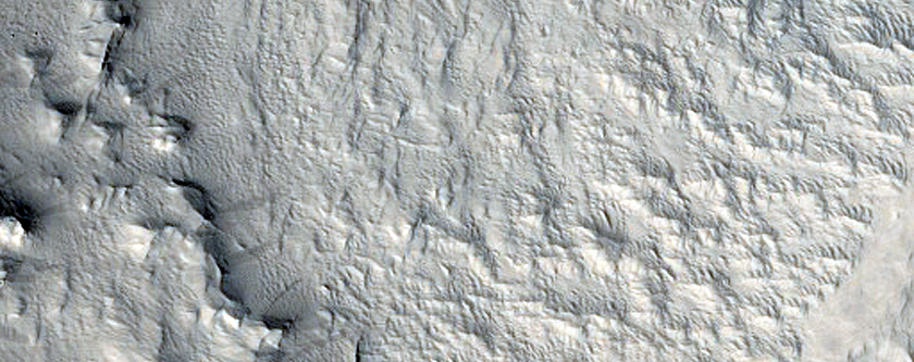 Layers at Edge of Pedestal Crater in Tikhonravov Crater
