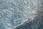 Shallow Channels Entering Collapse Terrain near Orson Welles Crater
