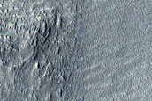 Tilted Layered Deposits in Small Crater in Terra Cimmeria 
