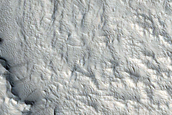 Layers at Edge of Pedestal Crater in Tikhonravov Crater