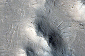 Dark-Toned Material in Depressions in Buttes and Plains in Aeolis Region