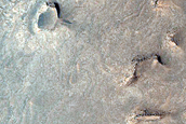 Light-Toned Layered Material in Depression in West Juventae Chasma