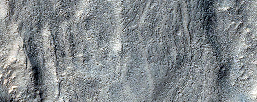 Curved Channels in Hellas Montes