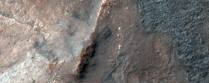 Bright Patches on Crater Floor in Thaumasia Planum