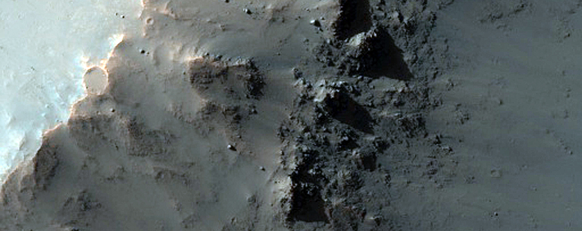 Clay and Pyroxene-Rich Materials Exposed by Crater in East Thaumasia Planum