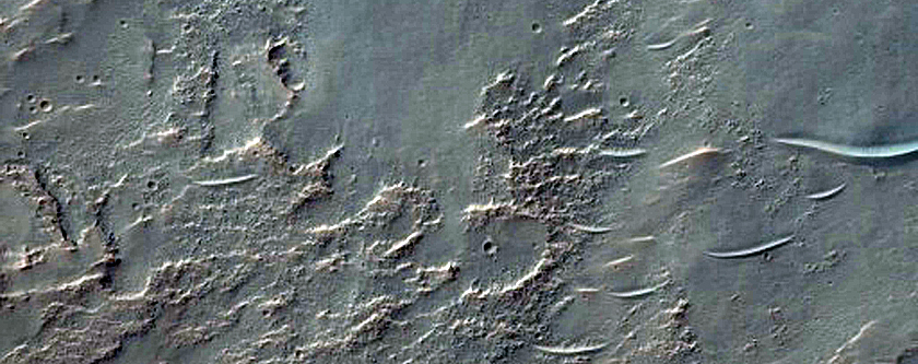 Possible Hydrated Materials on Rim of Crater in Thaumasia Planum