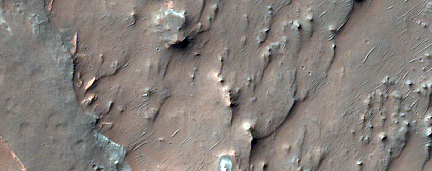 Bright Blocks in Eroded Materials near Thaumasia Planum