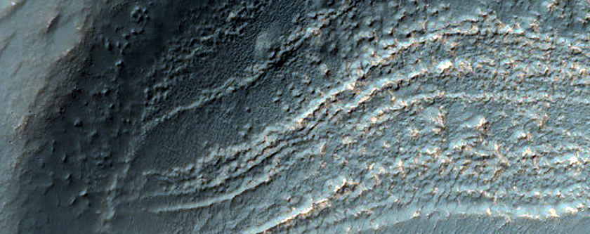 Exposed Layers of Bright Bedrock near Voeykov Crater