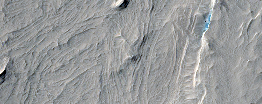 Layers and Ridges in Degraded Crater West of Lucus Planum