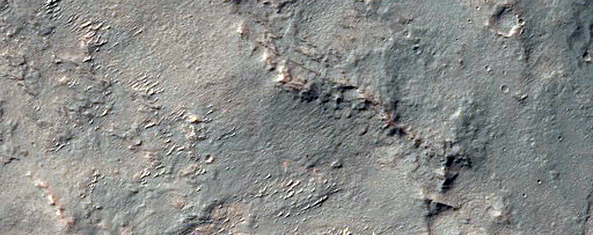 Olivine-Rich Materials on Eastern Scarp of Thaumasia Planum