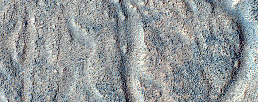 Chaos and Channels near Semeykin Crater