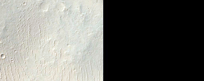 Compositionally Diverse Materials Exposed by Hesperia Planum Crater
