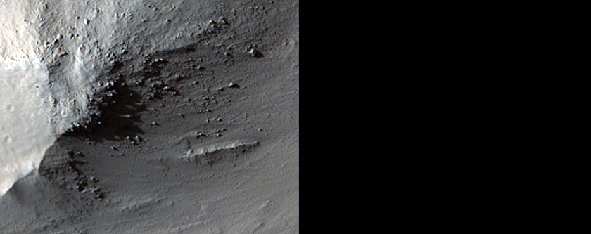Exposed Bedrock with Steep Slopes near 28-Meter Diameter Fresh Crater