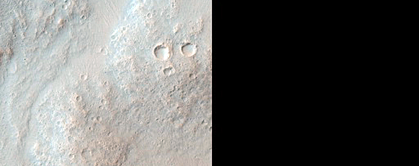 Impact Crater Exposing Bedrock