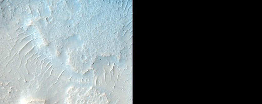 Light-Toned Material in Crater near Mouth of Kasei Valles