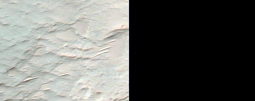 Exposed Portions of Uplift in 30-Kilometer Crater in Terra Sabaea