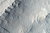 Layers at Edge of Pedestal Crater in Tikhonravov Crater