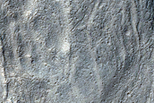 Curved Channels in Hellas Montes